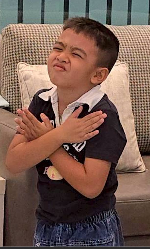 A child practising a self-soothing hands-on-heart gesture